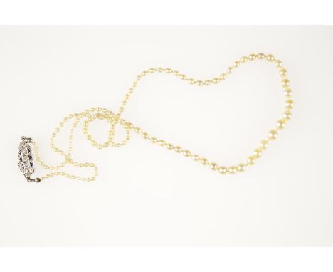 A GRADUATED CULTURED PEARL NECKLACE, the largest pearl c.5mm wide, the smallest c.1.9mm wide, knotted, united by an oval old-