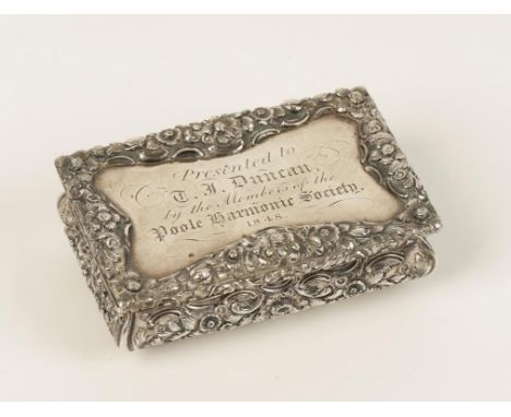 A VICTORIAN SNUFF BOX of rectangular form with a raised foliate border and cushion moulded sides, embossed with foliate scrol