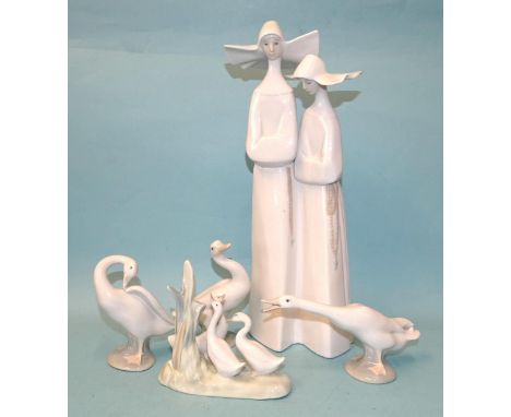 Lladro, a figurine depicting two nuns in habits, Lladro back stamp and impressed marks to base, 34cm high, together with thre