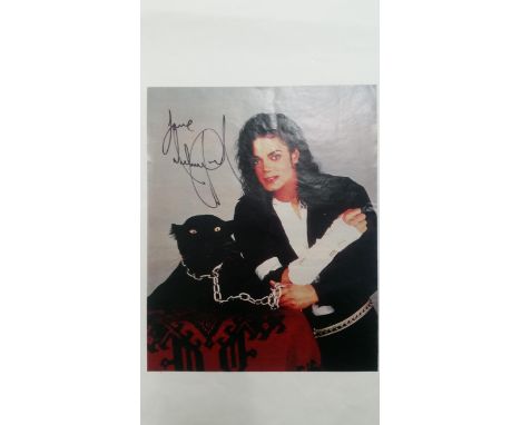 POP MUSIC, signed colour magazine page by Michael Jackson, showing him half-length with panther, 9 x 11.25, EX