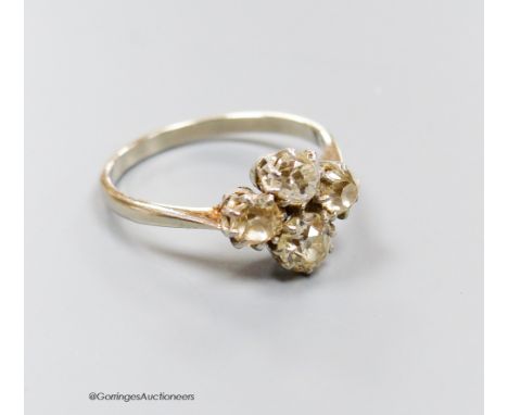   A white metal (stamped plat) and four stone diamond cluster ring, size O/P, gross 3.3 grams.