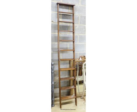   A Victorian oak 10 tread library ladder. W-38, H-229cm.