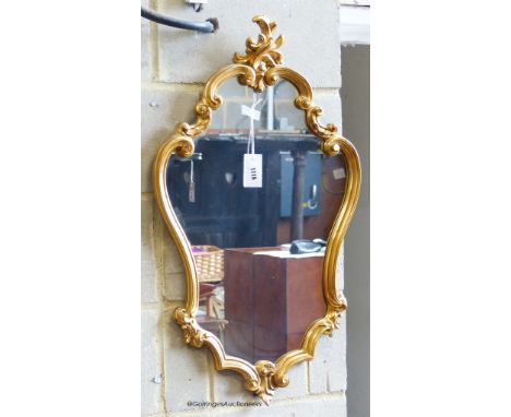   A George III style carved gilt wood mirror. W-70, H-124cm.