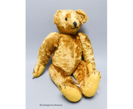 A cotton plush jointed teddy bear, 'Bingo',&nbsp;straw-filled,with boot button eyes, long snout and humped back (replacement 