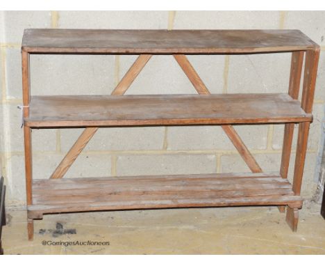  An Art nouveau pine three tier shelf or boot rack. W-108, D-28, H-78cm.