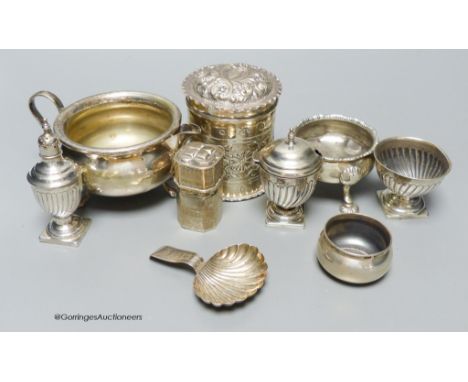   A group of small silver including a late Victorian repousse cannister, three salts, a caddy spoon, two condiments, A small 