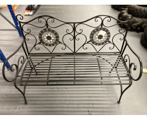 A metal two-seater garden bench with mosaic tiled back. 