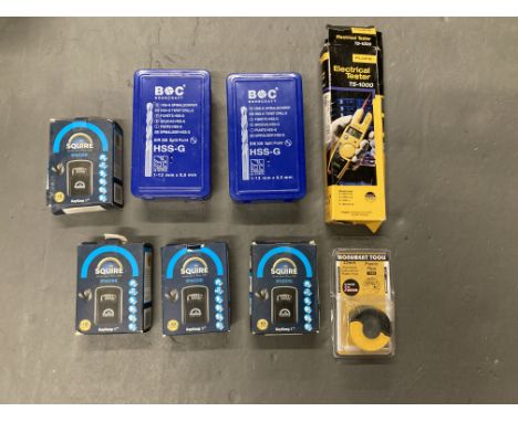 Two sets of BOC drill bits, together with a Fluke electrical tester, four Squire key boxes and a Monument Tool pipe fitting