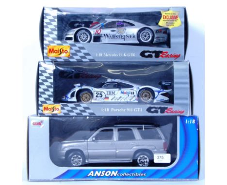 A collection of 3x 1:18 scale boxed diecast models. 2x Maisto GT Racing (Porsche 911 and Mercedes CLK GTR) and the other an A