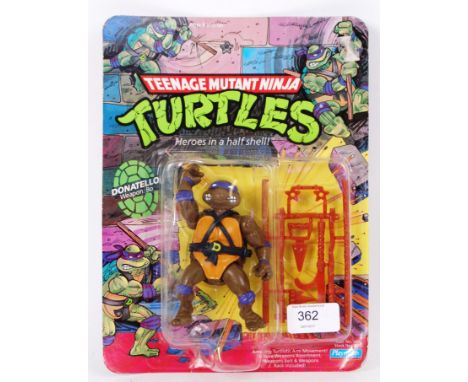 An original Playmates Teenage Mutant Ninja Turtles 10 back first release Donatello carded action figure. Unpunched. Sealed, u