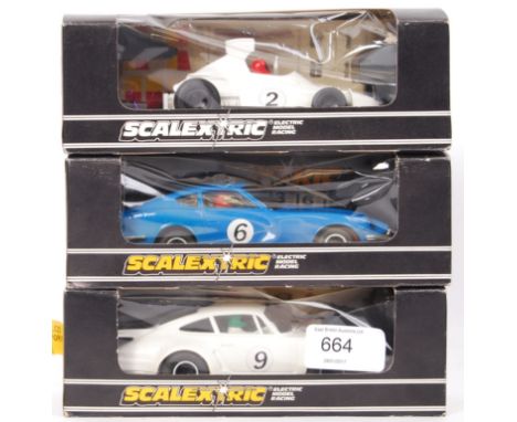 A collection of 3x vintage Scalextric racing cars - all appear to be unused, with unused decal sheets still to back of box. C
