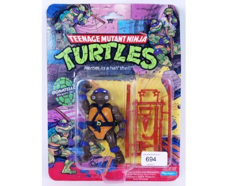 An original vintage Teenage Mutant Ninja Turtles carded 10 back first release Donatello action figure. By Playmates. Sealed, 