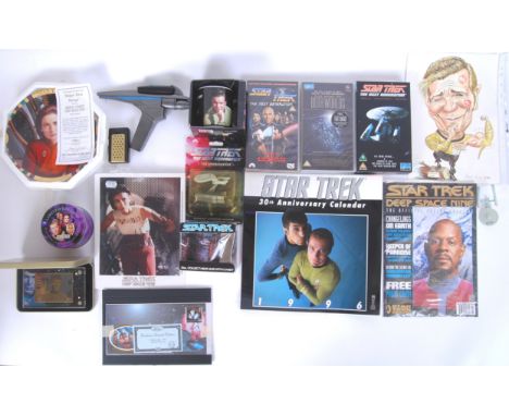 A collection of assorted Star Trek memorabilia to include a Spock 24k metal card, replica Phaser gun, Limited Edition ceramic
