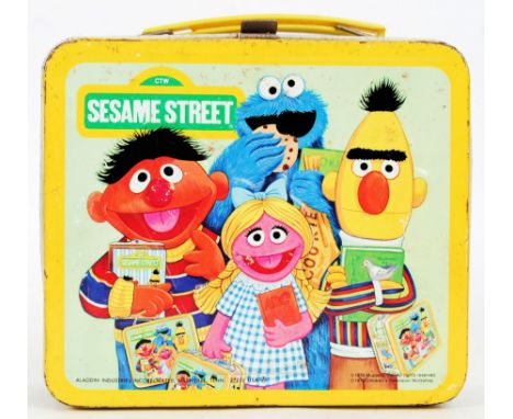 A vintage retro Sesame Street lunchbox, made by Aladdin Industries. Comes with original flask inside. With plastic carry hand