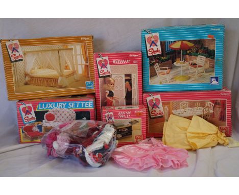 A collection of vintage 1980's Sindy accessories to include 44582 Dining tables and chairs, 44234 Luxury settee, 44386 Garden