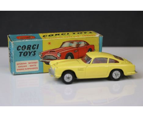 Boxed Corgi 218 Aston Martin DB4 diecast model in yellow with red interior, some paint chips, gd overall, gd box with some cr