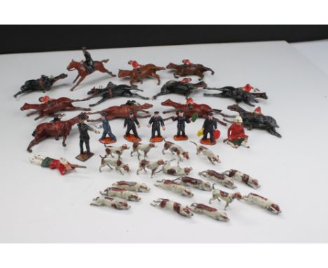 Collection of original Britains hunting metal figures to include many hounds, horse and riders, showing play wear, plus a gro