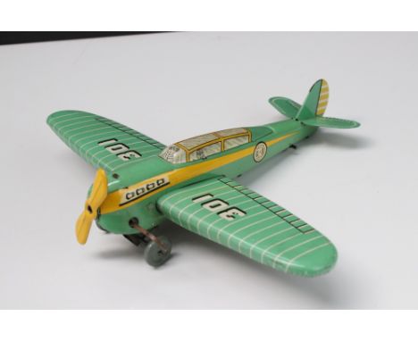Wells O London wind up tin plate model plane '301' in green with yellow, vg condition with propeller and minimal marks 