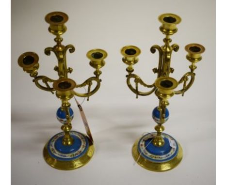 PAIR OF ATTRACTIVE PORCELAIN AND BRASS THREE BRANCH, FOUR LIGHT CANDELABRA. Each with scrolling arms and brass stem with porc