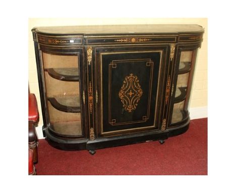 A VICTORIAN EBONISED AND BRASS-MOUNTED CREDENZA of breakfront outline. With central inlaid cupboard door enclosing a velvet l