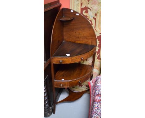 A GEORGE III PERIOD MAHOGANY CORNER WASH STAND, with arched gallery and shelf, the bow front with three mock drawers, and a l