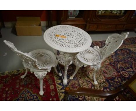 A HEAVY THREE PIECE CAST-IRON PATIO SET. Comprising two chairs, with pierced back and pierced circular seats. Raised on cabri