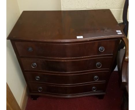 A GEORGE III STYLE SERPENTINE-SHAPED CHEST OF DRAWERS. O.R.M., Of small proportions, with four drawers and raised on bracket 