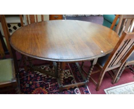 AN OVAL DROP LEAF OAK GATE LEG TABLE, with barley twist supports, 5ft (151cm) extended; together with a set of six oak triple