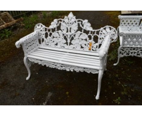 A HEAVY CAST-IRON GARDEN BENCH. Oak-leaf and acorn-moulded back with slatted seat. Flanked to either side with leaf-pierced a