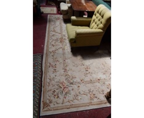 A FINE HEAVY WOOL-PILE AUBUSSON-STYLE CARPET, the beige field with all-over floral pattern within a conforming border. 11ft5 