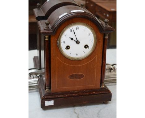 AN ARCHED TOP INLAID MAHOGANY MANTLE CLOCK. Early 20th century. The circular enamel dial with Arabic numerals, flanked to eit