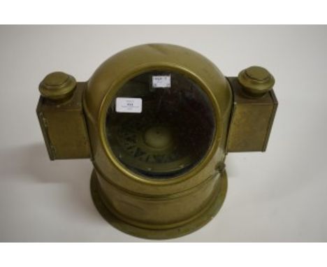 A HEAVY BRASS-CASED SHIP'S BINNACLE COMPASS, with circular glass panel and a cased lantern to either side. On circular base. 