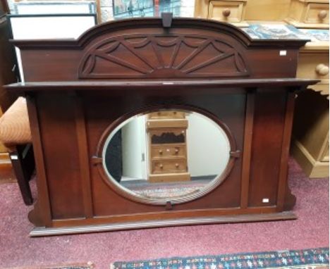 AN EDWARDIAN MAHOGANY OVERMANTEL OR CHIFFONIER BACK, with arched top above an oblong shelf and an oval mirror plate. 47" (119