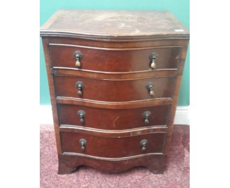 A SMALL GEORGIAN STYLE MAHOGANY BEDSIDE CHEST, O.R.M., the serpentine front with four drawers, and raised on splayed bracket 