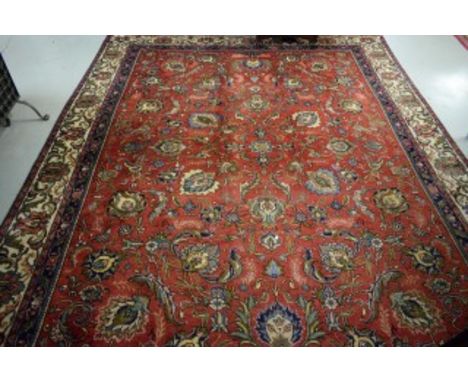 AN OLD PERSIAN TABRIZ CARPET. Burgundy ground with all-over floral pattern, inside an ivory border with smaller bands. 10ft 3