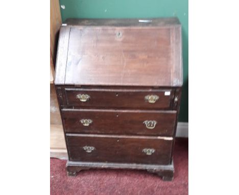 A NINETEENTH CENTURY SLOPE FRONT ELM AND OAK BUREAU. Front opening reveals a fitted interior with drawers and pigeon hole com