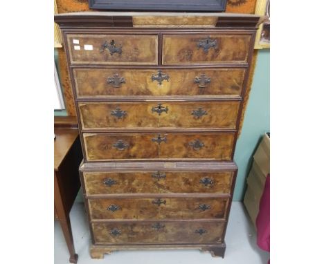 AN EARLY EIGHTEENTH CENTURY WALNUT CHEST ON CHEST, the moulded cornice above three long and two short drawers, each with herr