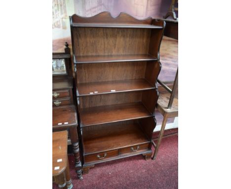 A GEORGIAN STYLE MAHOGANY OPENWORK BOOKCASE. O.R.M. With five shelves and two base drawers, raised on bracket feet. 59" (150c