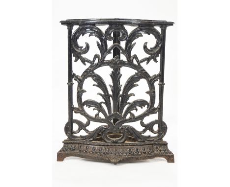 A cast iron corner stick stand, decorated with scrolling foliage, 61.5cm high x 43cm wide