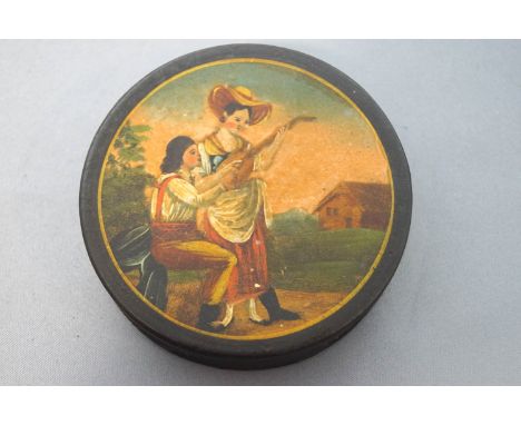 A 19th century papier mache snuff box, the cover painted with a lady and her companion, 8cm diameter