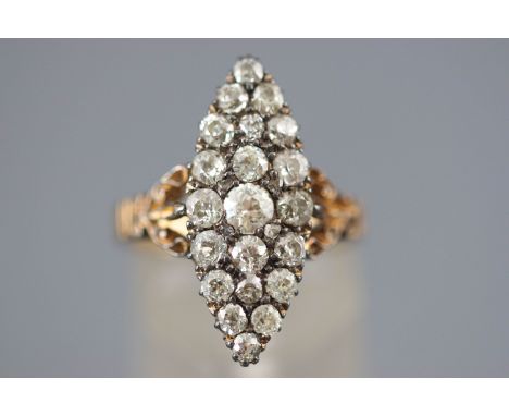 A yellow and white metal marquise shaped diamond dress ring set with a central old brilliant cut diamond of approximately 0.2