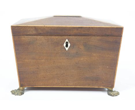 A 19th century sarcophagus shaped mahogany tea caddy with two lion mask and ring handles on paw feet, 20cm wide