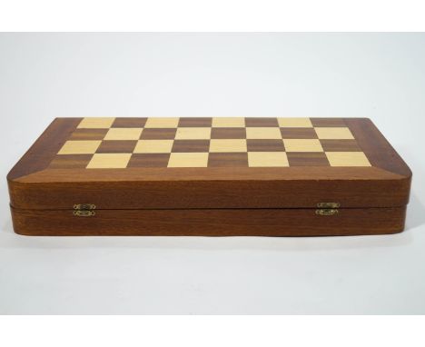  A chess set and board, the board of folding case form with rounded corners, inlaid with mahogany and other woods, opening on