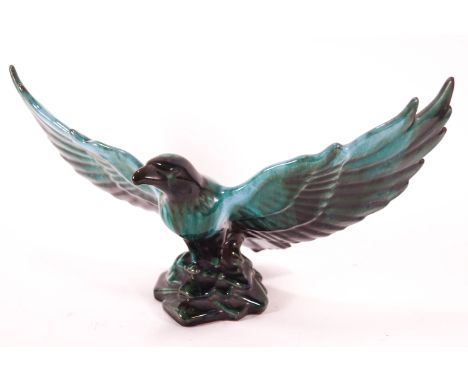 A large streaked Poole Pottery turquoise figure of an eagle taking flight, 20cm high x 37cm wide