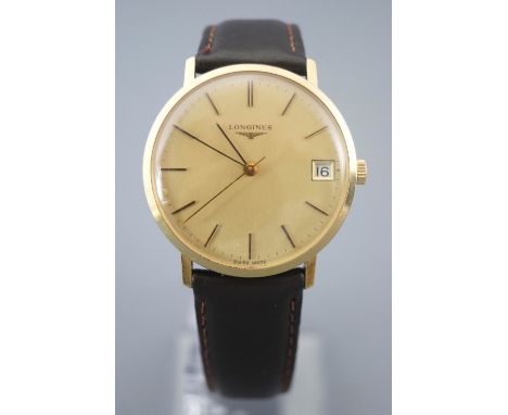 A gold plated Longines wristwatch. Round gold dial with baton markings and date feature. Manual wind movement. Case reference