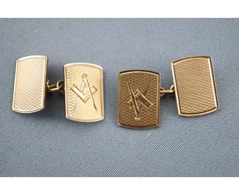 A yellow metal pair of panel cufflinks. Engine turned finished with masonic symbol; chain fittings. Hallmarked 9ct gold, Birm