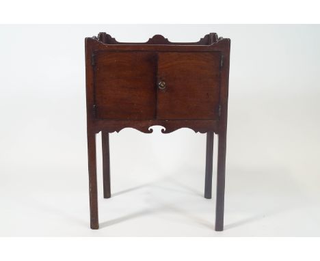 A 19th century mahogany commode with tray top above two doors on square legs, 71cm high x 50cm wide x 35cm deep