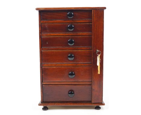 A mahogany and pine collector's cabinet of six graduated drawers with ceramic handles, 53.5cm high x 35.5cm wide x 26cm deep