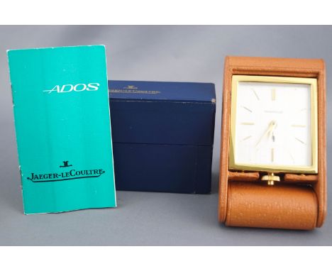 A Jaeger-le Coultre travel alarm clock in fitted tan leather case. Supplied with box and instructions.