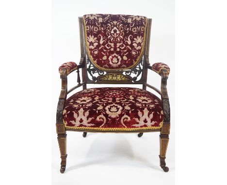 An Edwardian rosewood and ivory inlaid saloon chair on square tapering legs with ceramic casters